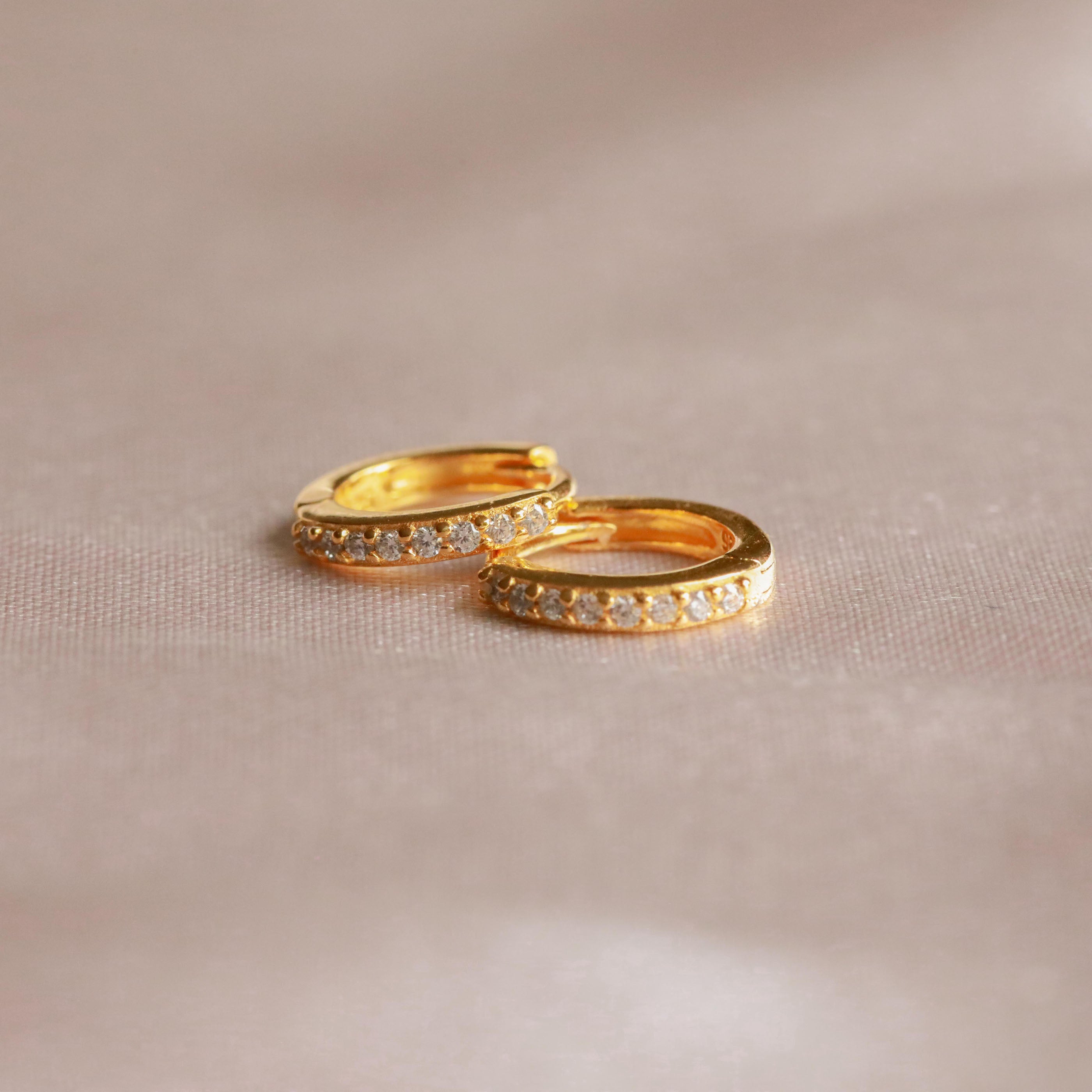 April Birthstone Huggies in Gold with White CZ